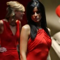 A model poses next to a Ferrari at the North American International Auto Show