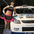 A model shows off Suzuki Motors' SX4 WRC prototype at the Tokyo Auto Salon