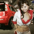 A model poses next to a Colt-custom car at the Mitsubishi motor's booth of the Tokyo Auto Salon