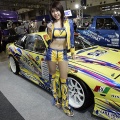 A model stands next to a Nissan 180SX-based custom car at the Tokyo Auto Salon